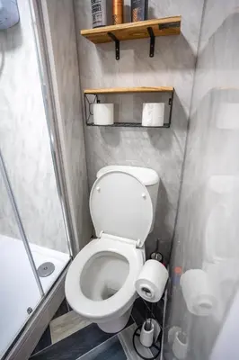 a small bathroom with a toilet and a shower at 1 BDR Apartment At Caledonia Luxe Stays Short Lets & Serviced Accommodation Airdrie in Airdrie