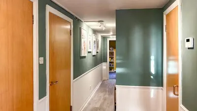 a hallway with green walls and a door at Sunny day new flat with 5 beds in Clydebank