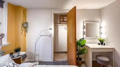 a bathroom with a shower and a table and a mirror at Sunny day new flat with 5 beds in Clydebank