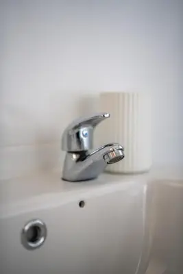 a bathroom sink with a silver faucet on it at Castlefern House in Rutherglen