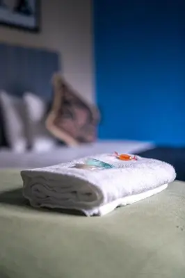 a folded towel sitting on top of a bed at Castlefern House in Rutherglen