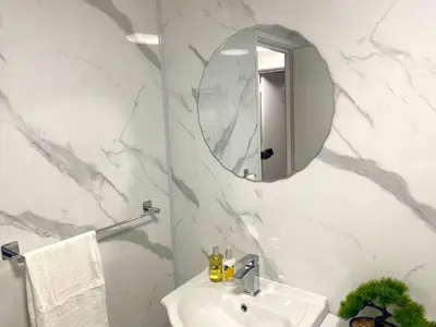 a white bathroom with a sink and a mirror at Charming home away from home! in Edinburgh