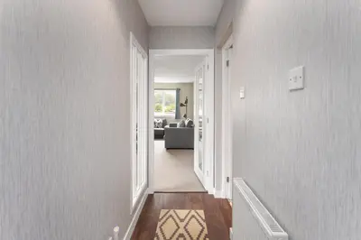 a hallway of a home with a living room at Modern flat near Murrayfield stadium, sleeps 4 in Edinburgh