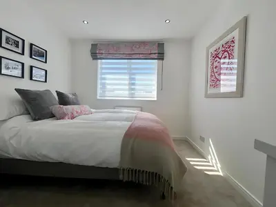 a bedroom with a large bed and a window at Dunmuir House 4 Bedroom 2 bathroom House & Garden in Denny in Falkirk