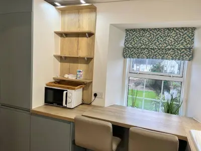 a kitchen with a counter with a microwave and a window at Harbour View Irvine in Irvine