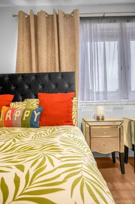 a bedroom with a bed and a window and a night stand at 3 Bedrooms Homely House in Motherwell Sleeps 8 comfortably with 6 double beds Near Glasgow Edinburgh Free Private Parking Business Travellers Contractors Holiday Goers Near all Major transport links in Carfin
