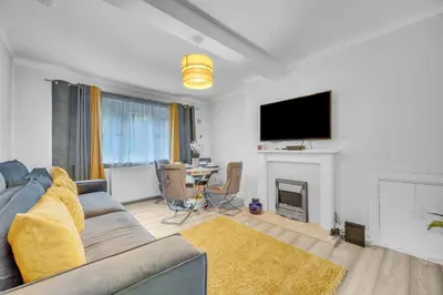 a living room with a couch and a tv at 3 Bedrooms Homely House in Motherwell Sleeps 8 comfortably with 6 double beds Near Glasgow Edinburgh Free Private Parking Business Travellers Contractors Holiday Goers Near all Major transport links in Carfin