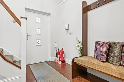 a hallway with a bench in a house at Westcraigs in Westfield