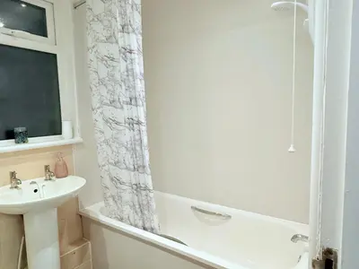 a white bathroom with a sink and a shower at RF-Entire House-Central Scotland-Falkirk, Self-Check-in , Pet-friendly and with Parking in Falkirk