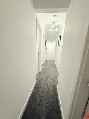 an empty hallway with white walls and a white door at RF-Entire House-Central Scotland-Falkirk, Self-Check-in , Pet-friendly and with Parking in Falkirk