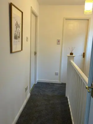 a hallway with a white door and a staircase at KH-Entire House -Central Scotland, Self-Check-in , Pet-friendly and with Parking in Falkirk