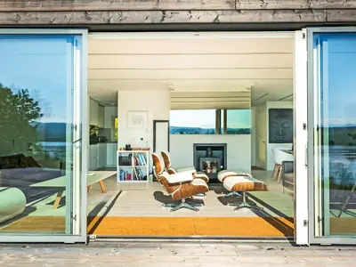 a living room with large sliding glass doors at Ferry House in Bonawe