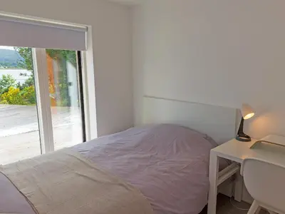 a bedroom with a bed and a desk and a window at Ferry House in Bonawe