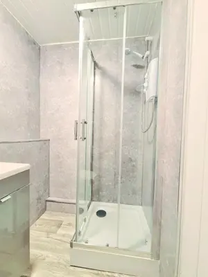a shower with a glass door in a bathroom at Cozy Flat in Glasgow City Centre in Glasgow