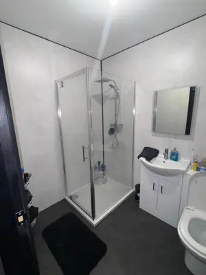 a bathroom with a shower and a sink at Langside apartments 2 in Newhouse