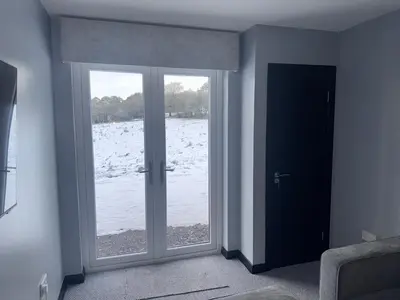 an empty room with a door and a window at Langside apartments 2 in Newhouse