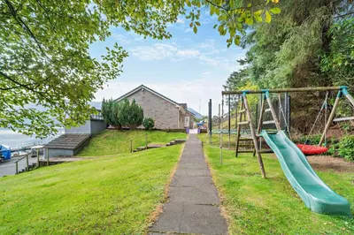 a playground in a park with a slide at 4 Bed in Lochgoilhead oc-j30107 in Carrick