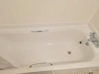 a white bath tub with a faucet in a bathroom at Cosy flat in Glasgow in Maryhill