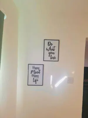 three signs on a white wall in a room at Cosy flat in Glasgow in Maryhill
