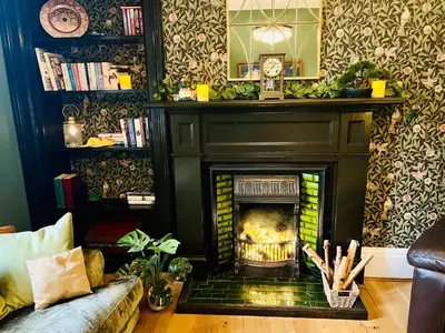 a living room with a fireplace and a couch at Carvetii - Abbey View, 1st Floor Flat, City Centre in Dunfermline
