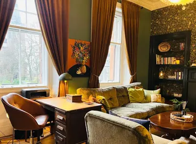a living room with a couch and a table at Carvetii - Abbey View, 1st Floor Flat, City Centre in Dunfermline