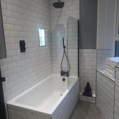 a white bathroom with a tub and a mirror at Carvetii - Abbey View, 1st Floor Flat, City Centre in Dunfermline
