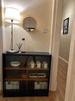 a shelf with cups and a lamp and a mirror at VS-Entire Flat-Central Scotland-Falkirk, Self-Check-in , Pet-friendly with Parking in Falkirk