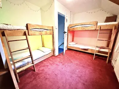 a room with two bunk beds and a doorway at Cosy Cottage with Woodburner by Crinan Canal Pets Welcome in Cairnbaan