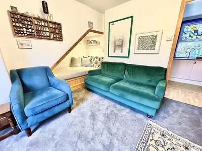 a living room with a couch and a chair and a bed at Cosy Cottage with Woodburner by Crinan Canal Pets Welcome in Cairnbaan