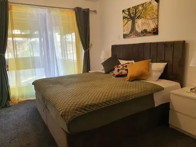 a bedroom with a large bed with a window at The River Inn in Killin