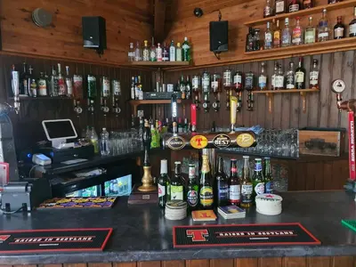 a bar with a lot of bottles of alcohol at The River Inn in Killin