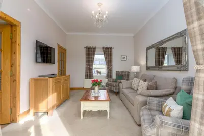 a living room with a couch and a table at 2 Bed in Rosyth oc-r30512 in Rosyth