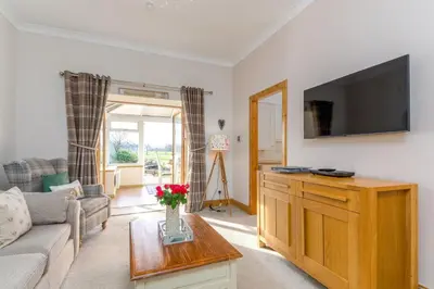 a living room with a couch and a tv at 2 Bed in Rosyth oc-r30512 in Rosyth