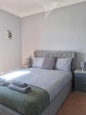 a bedroom with a large bed with lights on it at Campbeltown Harbour View in Campbeltown