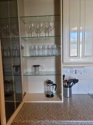 a cupboard with glasses and a blender in a kitchen at Campbeltown Harbour View in Campbeltown