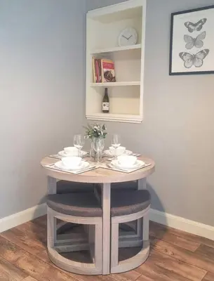 a small table with glasses and plates on it at Campbeltown Harbour View in Campbeltown