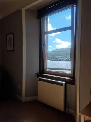 a window with a radiator and a view of the water at Campbeltown Harbour View in Campbeltown