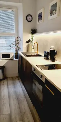 a kitchen with a sink and a counter top at 17 Oban in Oban