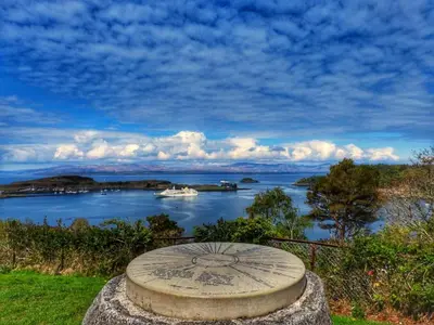 a stone bench with a view of a body of water at 17 Oban in Oban