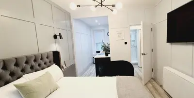 a bedroom with a large bed and a desk at 17 Oban in Oban