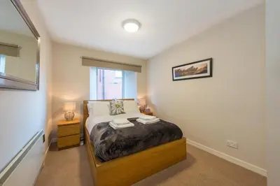 a bedroom with a bed with two towels on it at The Maltings in Edinburgh