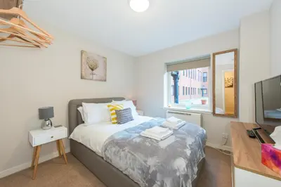 a bedroom with a bed and a desk and a window at The Maltings in Edinburgh