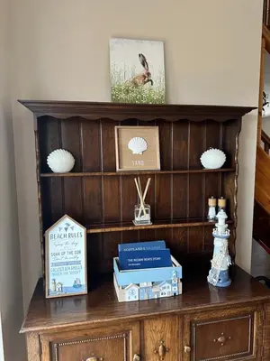a wooden cabinet with boxes on top of it at Church Bay House Rathlin in Rathlin Island