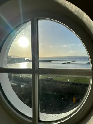 a view of the ocean through a window at Church Bay House Rathlin in Rathlin Island