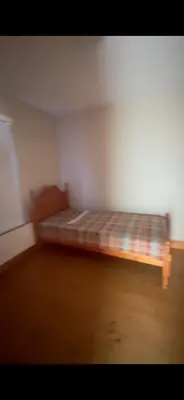 a room with a bed in the corner of a room at Church Bay House in Rathlin Island