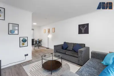 a living room with a couch and a table at Modern 3 Bed Home in Bathgate with Garden in Armadale