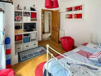 a bedroom with a bed and a tv in a room at Heatherdale in Dunoon