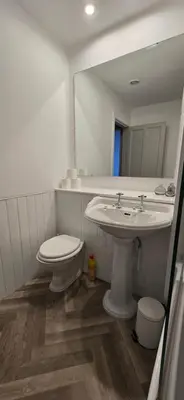 a bathroom with a sink and a toilet and a mirror at 2 Bedroom Sofa bed in livingroom Castle View 1st floor sleeps 6 in Edinburgh