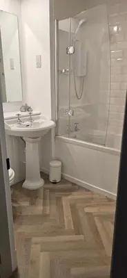 a bathroom with a sink and a shower at 2 Bedroom Sofa bed in livingroom Castle View 1st floor sleeps 6 in Edinburgh
