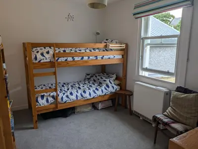 a bedroom with two bunk beds and a window at Tigh Grianach in Port Charlotte